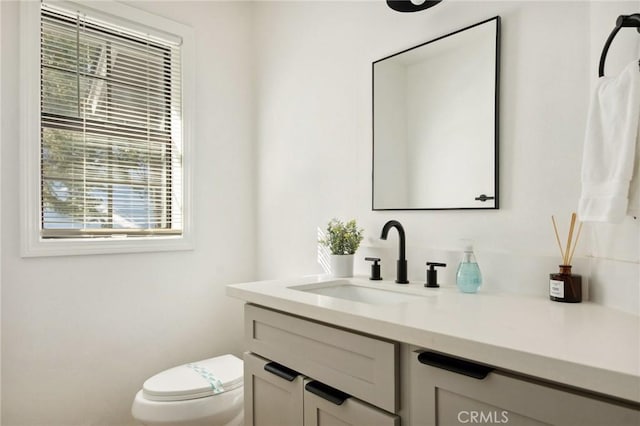 bathroom featuring vanity and toilet