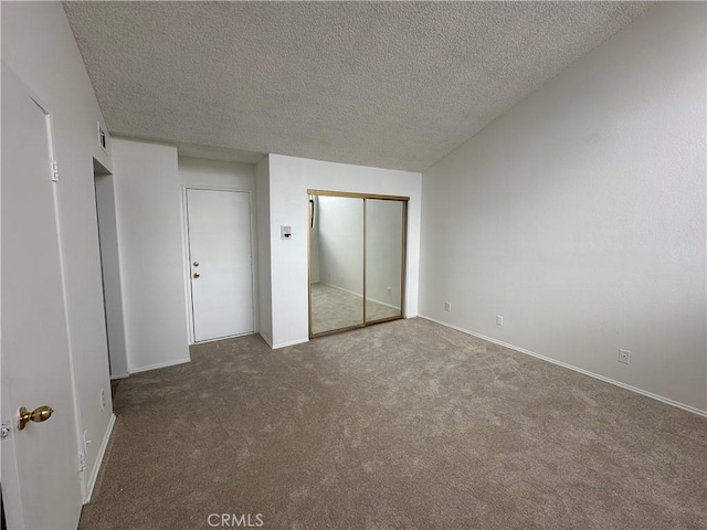 unfurnished bedroom with a textured ceiling and carpet