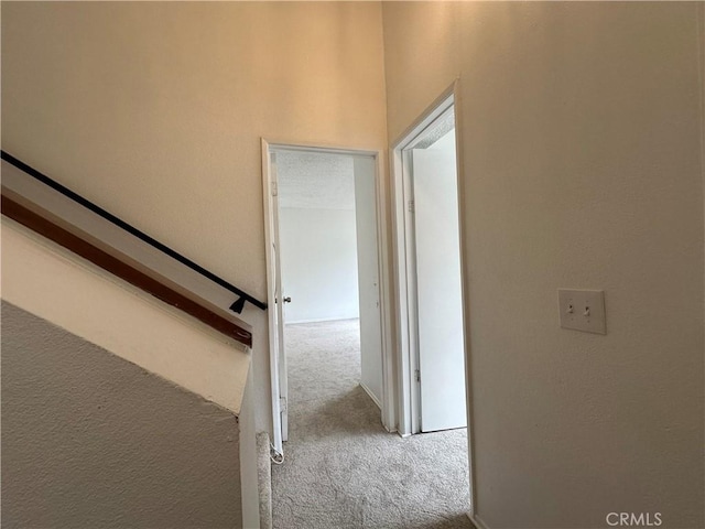 corridor featuring light colored carpet