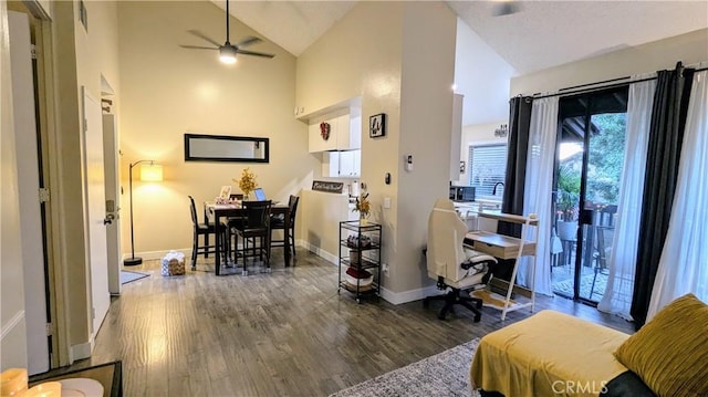 interior space featuring dark wood-type flooring, high vaulted ceiling, and ceiling fan