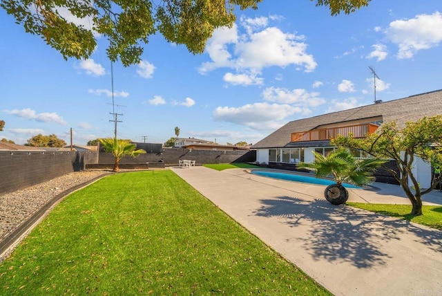 view of yard featuring a fenced in pool and a patio area