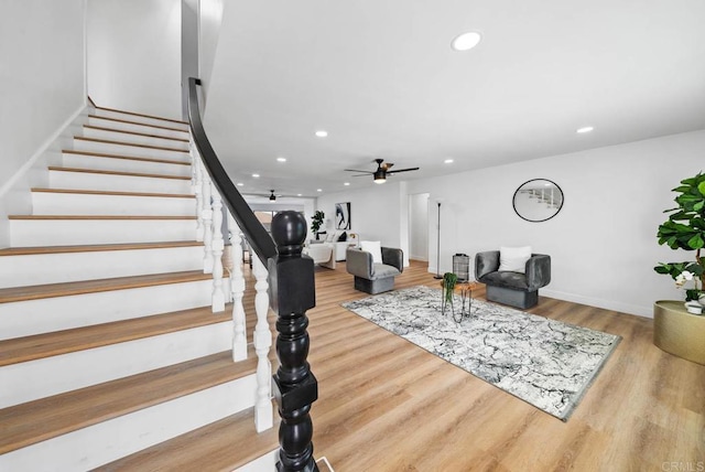 living room with hardwood / wood-style floors and ceiling fan