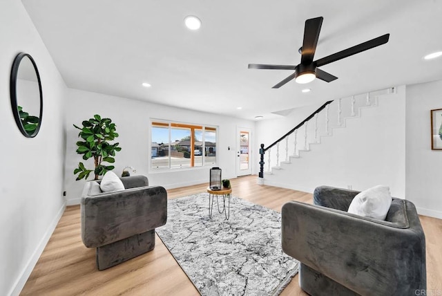 living room with ceiling fan and light hardwood / wood-style floors