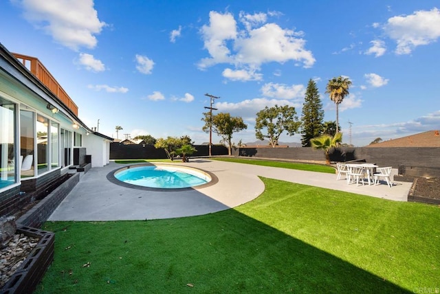 view of swimming pool featuring a patio and a lawn