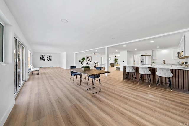 dining area featuring ceiling fan and light wood-type flooring