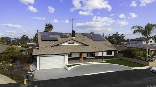 view of front facade featuring solar panels