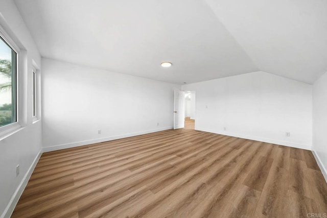 interior space with hardwood / wood-style flooring and vaulted ceiling