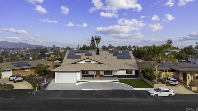 view of front of home featuring a garage and solar panels