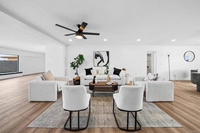 living room featuring ceiling fan and light hardwood / wood-style floors