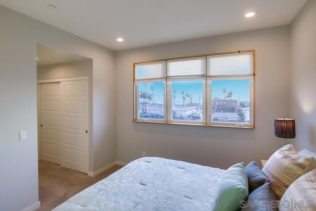 bedroom featuring light carpet