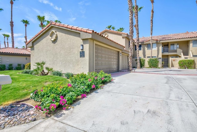 view of front of property featuring a garage and a front lawn