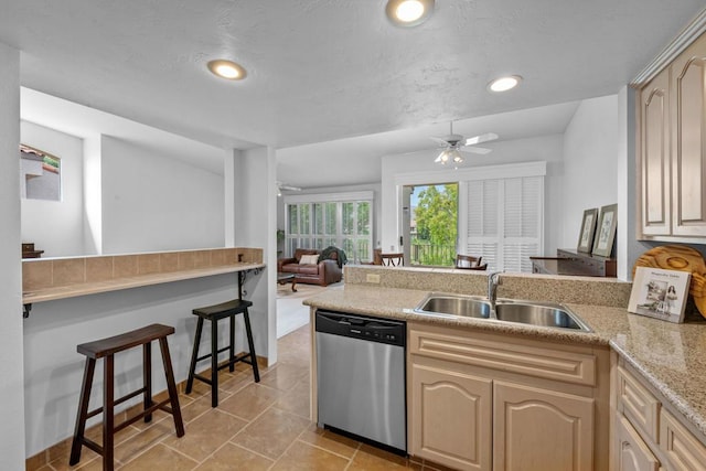 kitchen featuring sink, light tile patterned floors, dishwasher, and ceiling fan