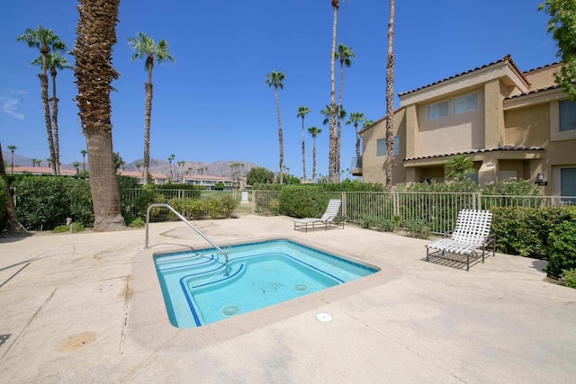 view of swimming pool with a hot tub and a patio area