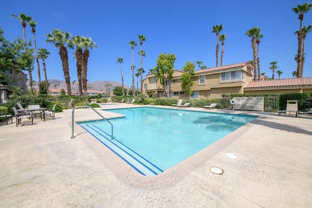 view of pool featuring a mountain view and a patio