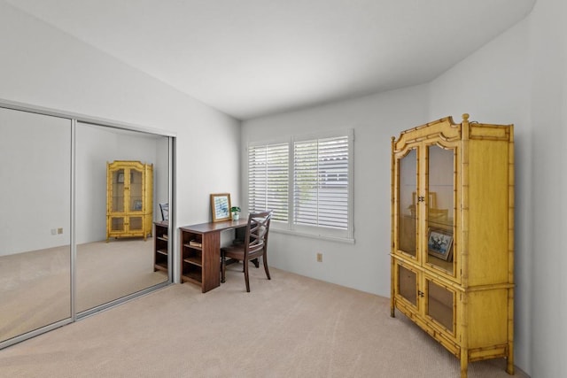 carpeted office space featuring vaulted ceiling