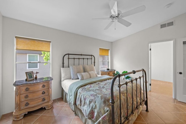 tiled bedroom featuring ceiling fan