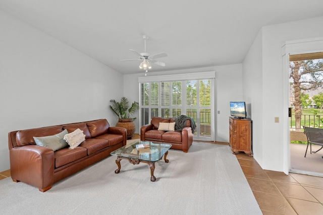 tiled living room featuring lofted ceiling and ceiling fan