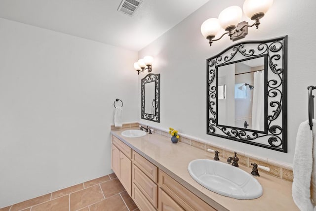 bathroom featuring vanity, tile patterned flooring, an inviting chandelier, and walk in shower