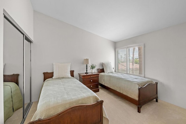 carpeted bedroom with a closet