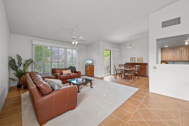 living room featuring light tile patterned flooring, high vaulted ceiling, and ceiling fan