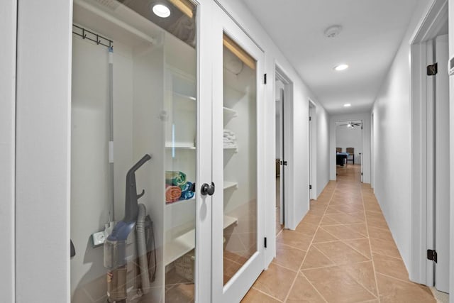 hall with light tile patterned floors