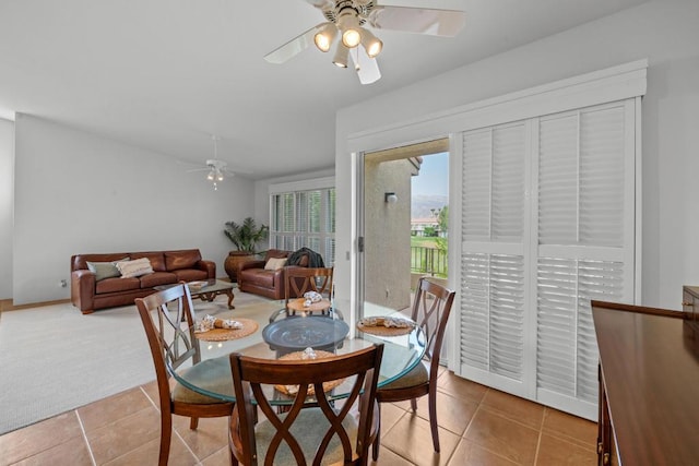 dining space featuring tile patterned flooring and ceiling fan