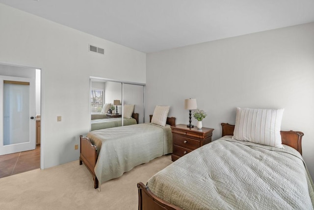 carpeted bedroom with a closet