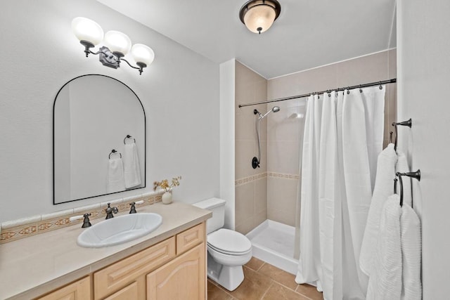 bathroom with vanity, toilet, curtained shower, and tile patterned flooring