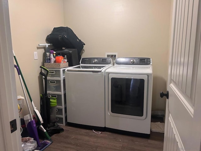 clothes washing area with separate washer and dryer and dark hardwood / wood-style floors