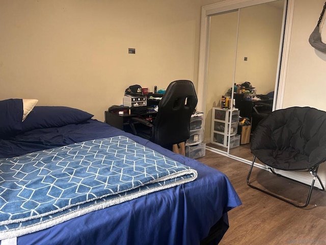 bedroom with hardwood / wood-style flooring and a closet