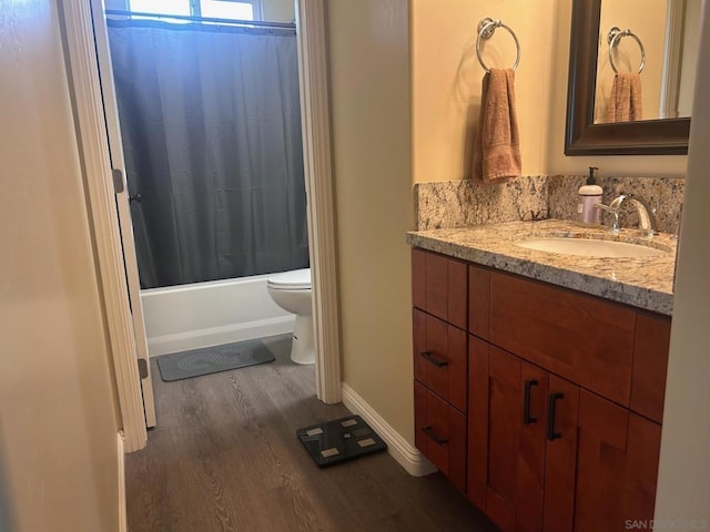 full bathroom featuring shower / bath combination with curtain, wood-type flooring, vanity, and toilet