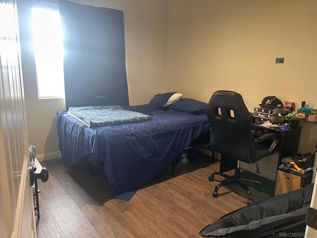 bedroom featuring dark wood-type flooring