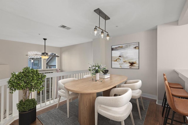 dining space featuring ceiling fan and dark hardwood / wood-style flooring