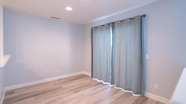 spare room featuring light hardwood / wood-style flooring