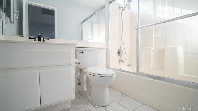 full bathroom featuring vanity, toilet, and combined bath / shower with glass door