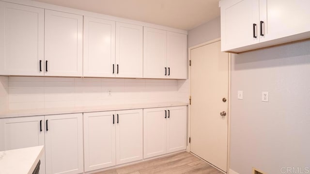 laundry room with light hardwood / wood-style flooring