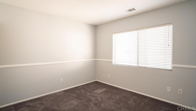 carpeted spare room with a healthy amount of sunlight