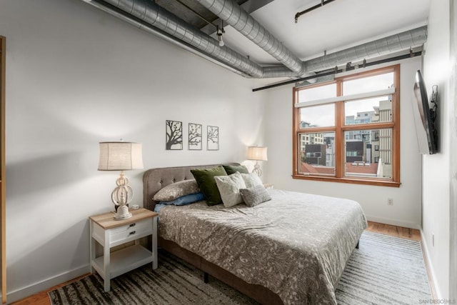 bedroom with hardwood / wood-style floors