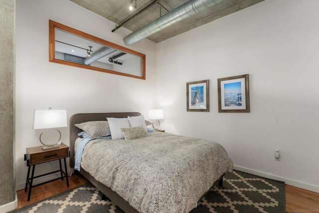 bedroom featuring dark hardwood / wood-style flooring