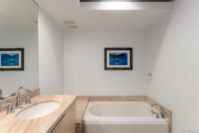 bathroom featuring vanity and a bath