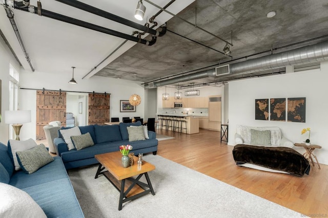 living room featuring hardwood / wood-style flooring and a barn door