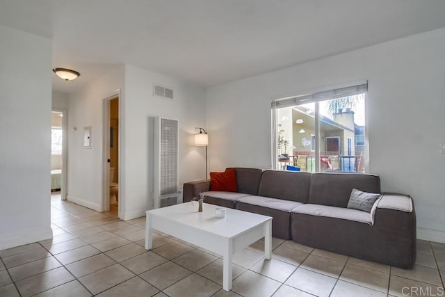 living area featuring visible vents, baseboards, and light tile patterned floors