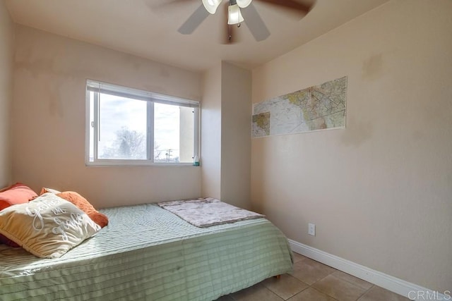 bedroom featuring light tile patterned floors, ceiling fan, and baseboards