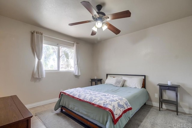 bedroom featuring ceiling fan, baseboards, and light tile patterned floors