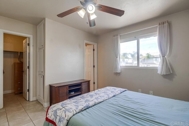 bedroom featuring light tile patterned floors, ceiling fan, and baseboards