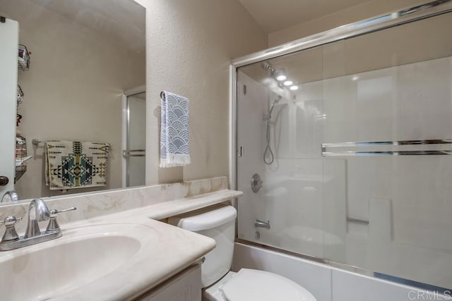 full bathroom featuring toilet, vanity, and enclosed tub / shower combo