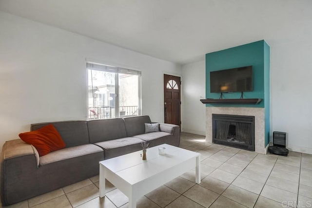 living room with light tile patterned floors and a tiled fireplace