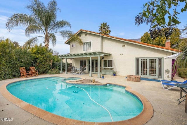 view of pool featuring french doors, an in ground hot tub, a patio area, and a pergola