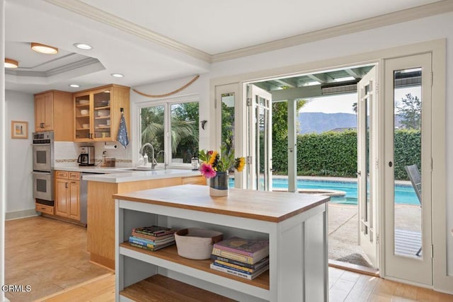 kitchen featuring appliances with stainless steel finishes, ornamental molding, a center island, and a mountain view