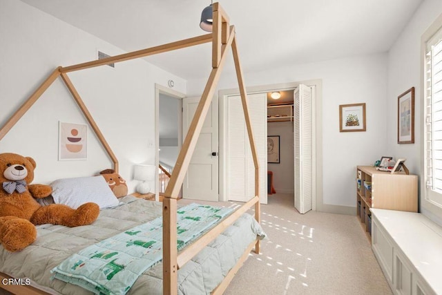 bedroom with light carpet and a closet